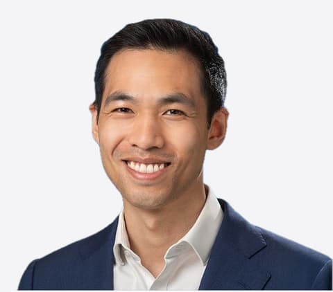 Dr Dun Jack Fu smiling, in a navy jacket