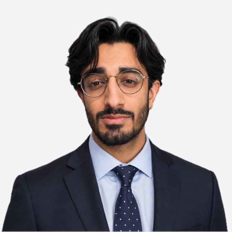 Dr Parivrudh Sharma in a navy suit and glasses